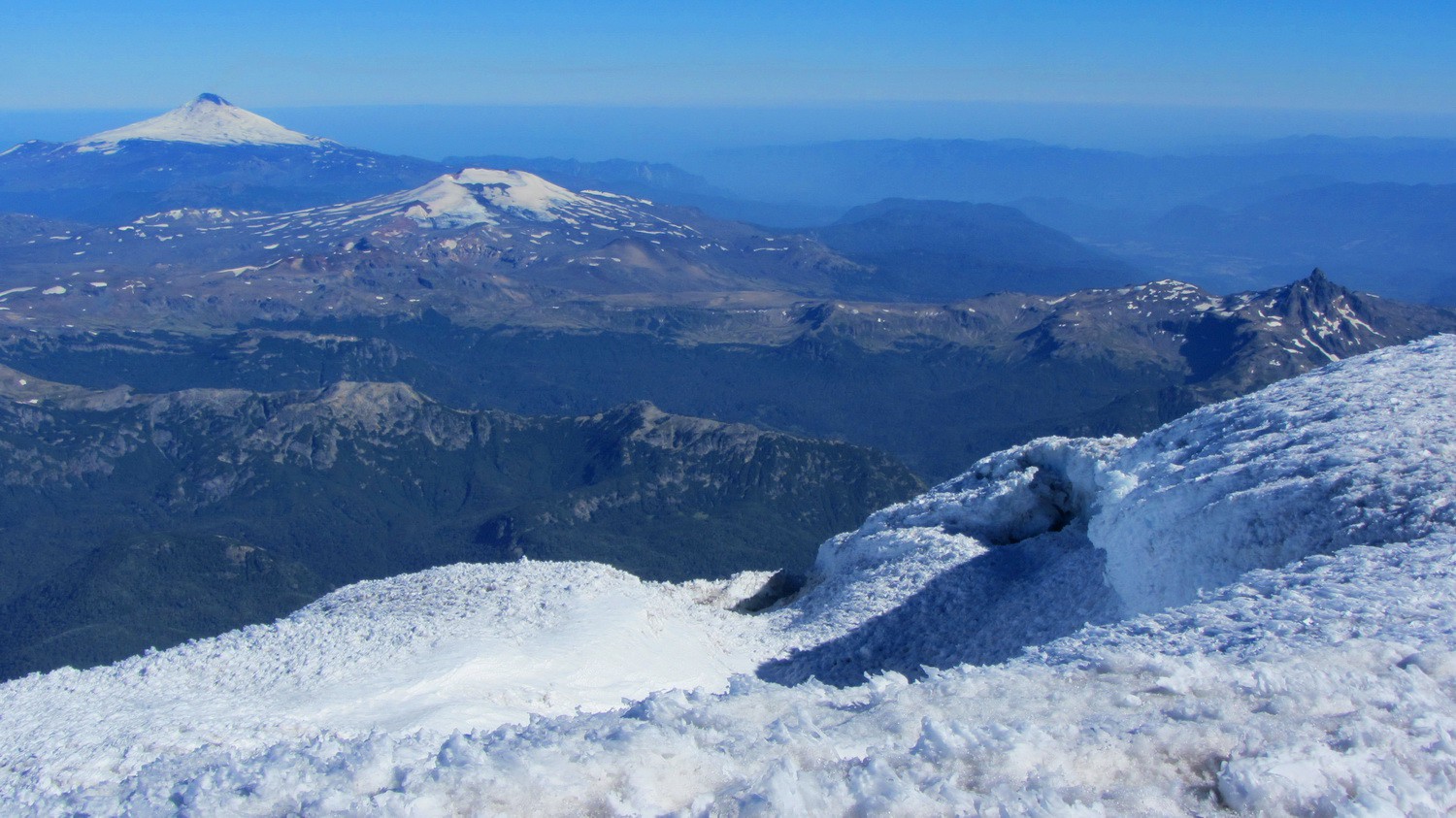 Volcanoes Villarrica and Quetrupillan from the top of Volcan Lanin